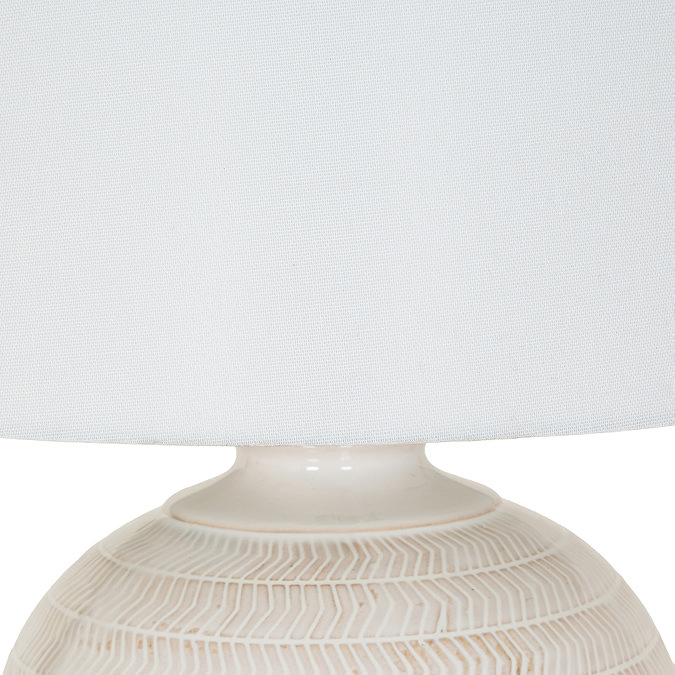 close up on white linen shade of ceramic table lamp