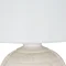 close up on white linen shade of ceramic table lamp