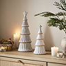pair of alora ceramic christmas trees displayed on a sideboard with cosy candles.