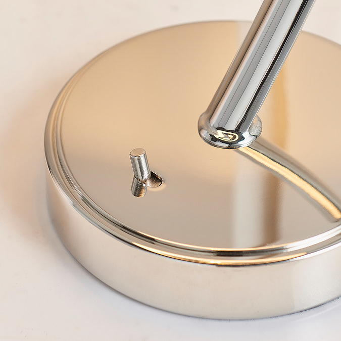 close up on shiny nickel-plated base of table lamp