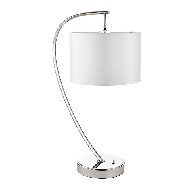 image cut out on white background of gently arched nickel table lamp with faux silk white shade