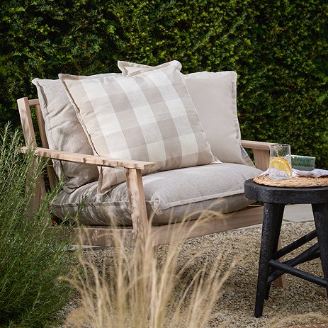 Chesil check outdoor cushion in natural lifestyle image 1