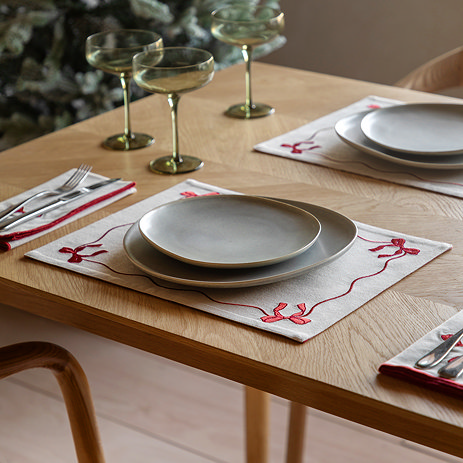 Christmas Bows placemats on dining table with cutlery