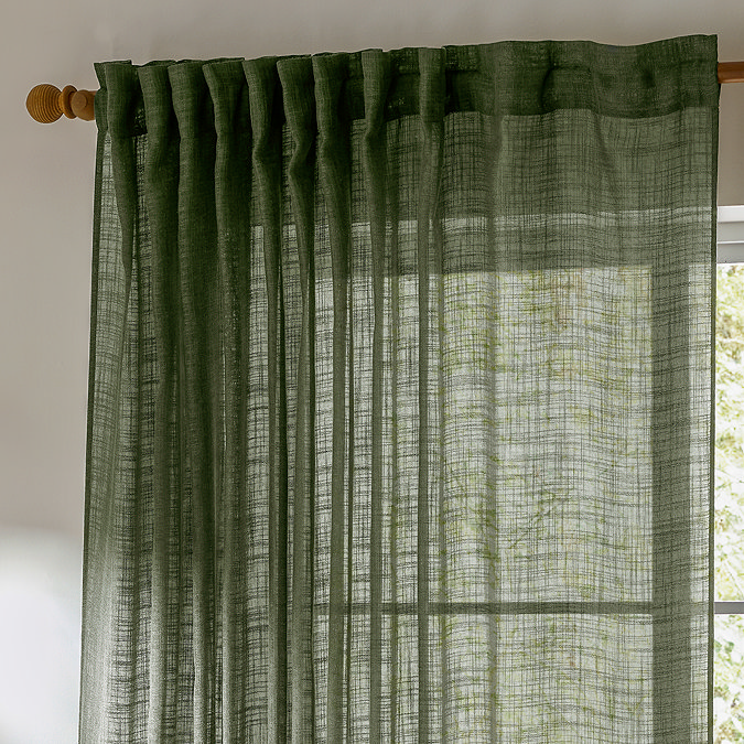 Cirrus Tab Top Sheer Curtain Panel in Forest Green close up in front of a window image