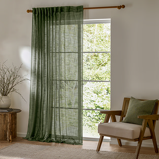 Cirrus Tab Top Sheer Curtain Panel in Forest Green in front of a window image