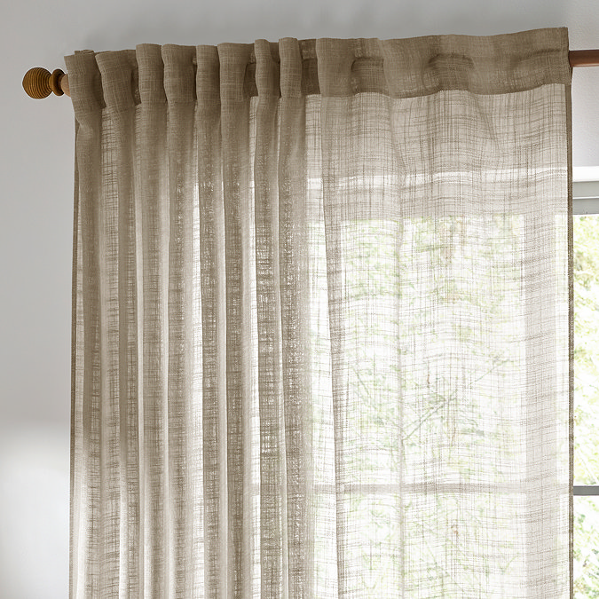 Cirrus Tap Top Sheer Curtain Panel in Linen over a window close up image