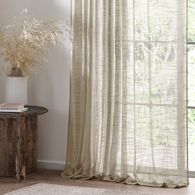 Cirrus Tap Top Sheer Curtain Panel in Linen over a window close up image