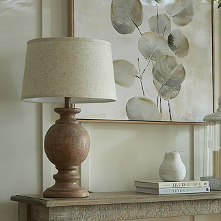 image of brown wooden table lamp with linen shade, on a console table