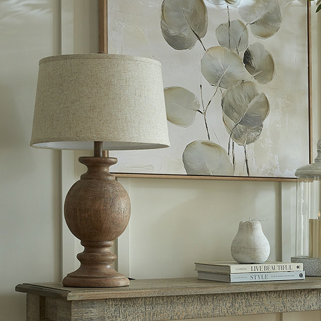 image of brown wooden table lamp with linen shade, on a console table
