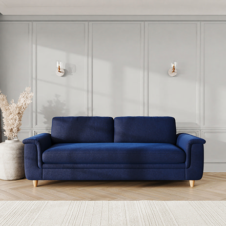 lifestyle image of grand sofa with sculpted arms and light oak feet, in indigo velvet fabric