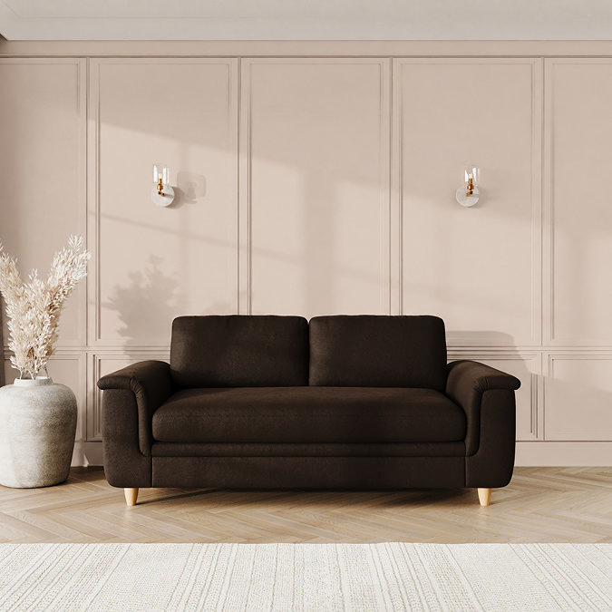 lifestyle image of large sofa with sculpted arms and light oak feet, in cocoa velvet
