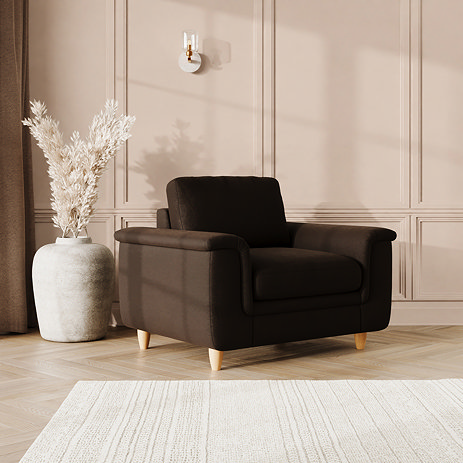 lifestyle image of snuggle chair with sculpted arms and light oak feet, in cocoa velvet