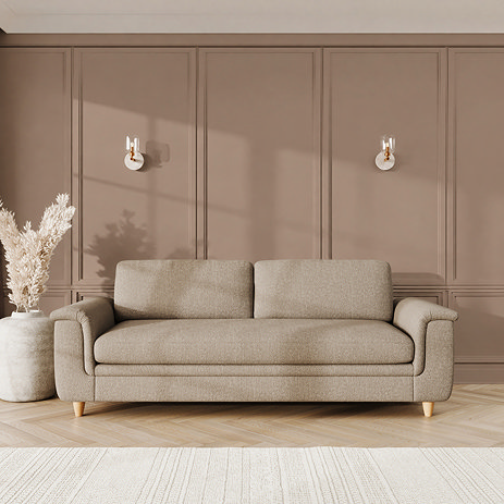 lifestyle image of grand sofa with sculpted arms and light oak feet in a latte coloured fabric