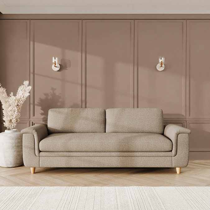 lifestyle image of grand sofa with sculpted arms and light oak feet in a latte coloured fabric