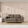 lifestyle image of large sofa with sculpted arms and light oak feet, in fallow chenille-velvet fabric
