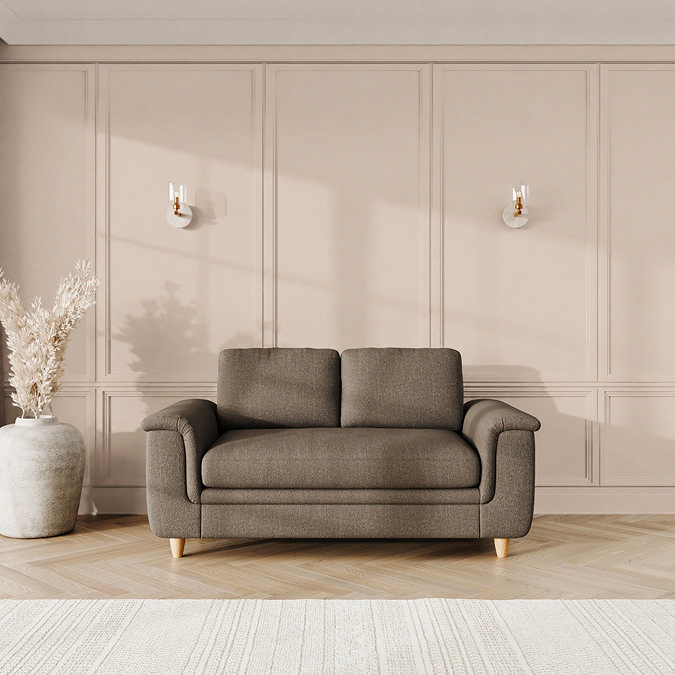 lifestyle image of grand sofa with sculpted arms and light oak feet, in fallow fabric
