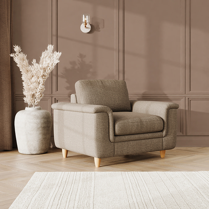 lifestyle image of snuggle chair with sculpted arms and light oak feet, in latte fabric