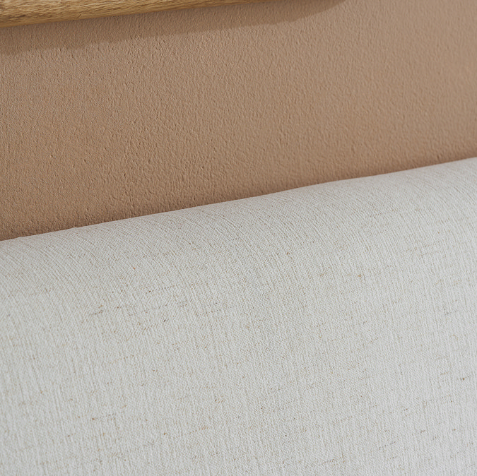 close up on linen texture of cream headboard of bed