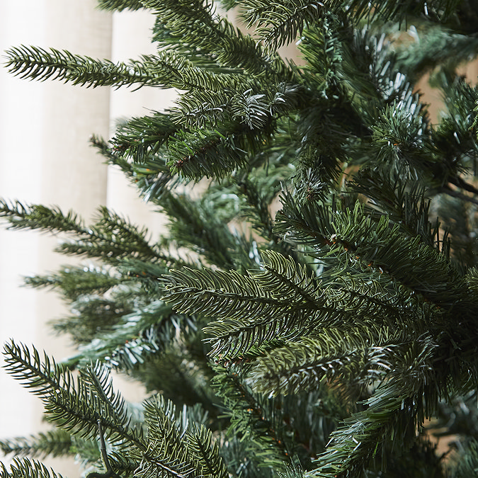 close up on lush green branches of the artificial coniferous spruce tree