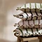 stack of connie striped cushions in four different cushions, piled on a small side table.