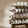 stack of four striped cushions in different colours, piled on a small side table