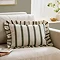 moss green striped rectangular cushion sat on a cream sofa.