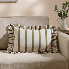 rectangular cushion with wide linen and narrow olive green stripes, sat on a cream sofa.