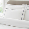 Contrast trim duvet cover set in white and black on bed image 2