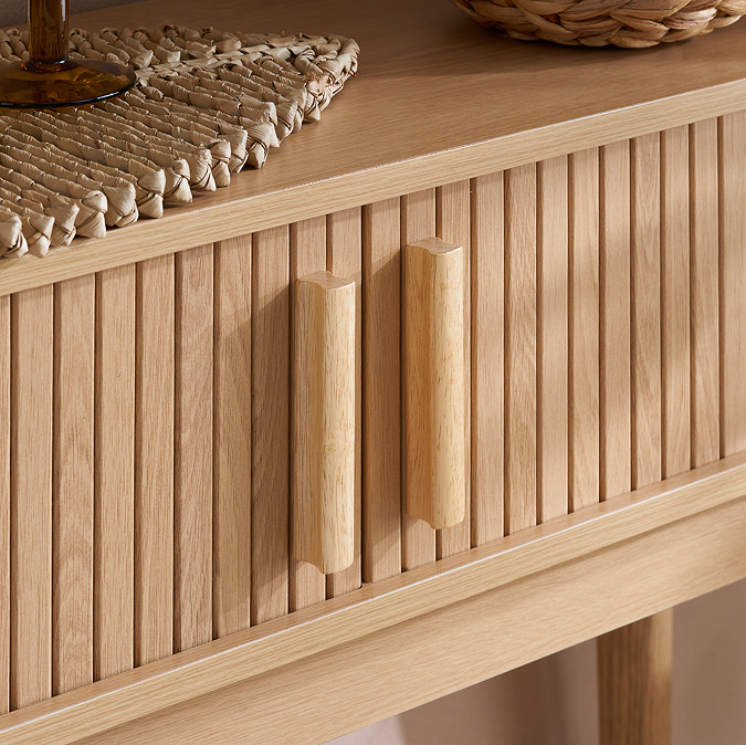 close up on fluted wooden texture of oak console table with sleek rectangular vertical handles