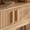 close up on fluted wooden texture of oak console table with sleek rectangular vertical handles