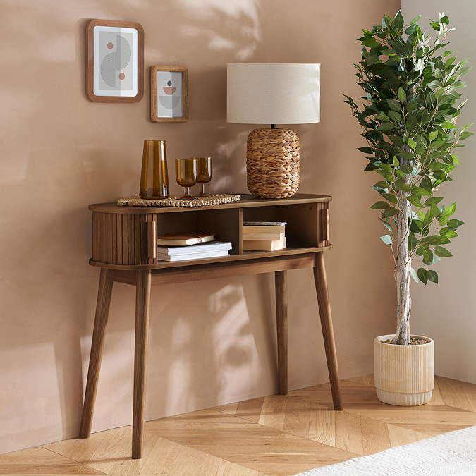 walnut console table with doors open to reveal two storage spaces holding books