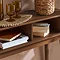 close up on inside of console table with two storage spaces holding books