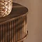 close up on smooth rounded top/edge and fluted side of walnut console table