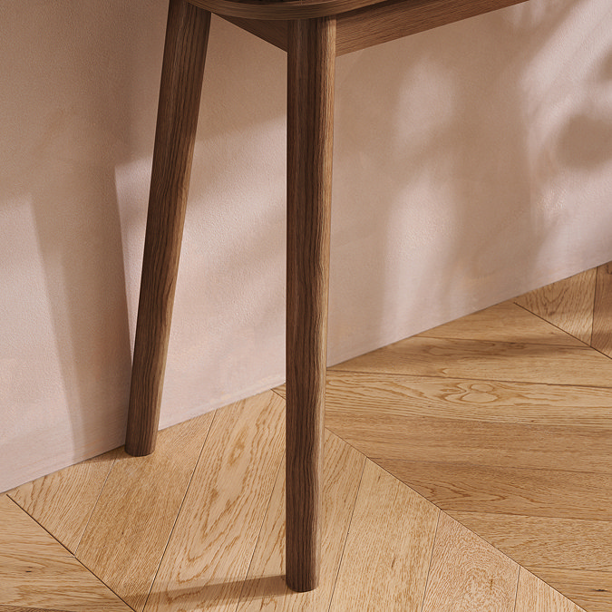 close up on dark brown slim left legs of console table