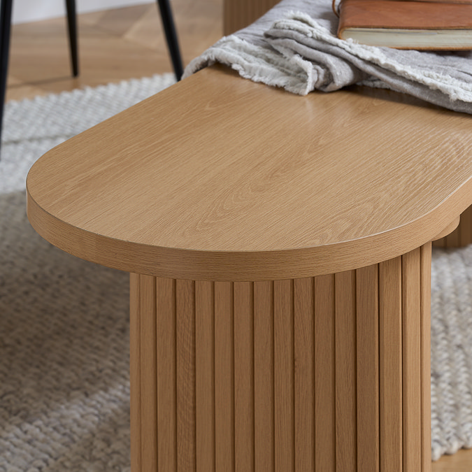 close up image of smooth oak top of wooden dining bench, with fluted legs