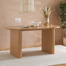 wide shot of oak oval dining table without chairs in the shot