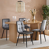 oval oak dining table with two stocky  fluted legs and four grey chairs around it