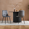image of black fluted round dining table with two grey chairs sat at it