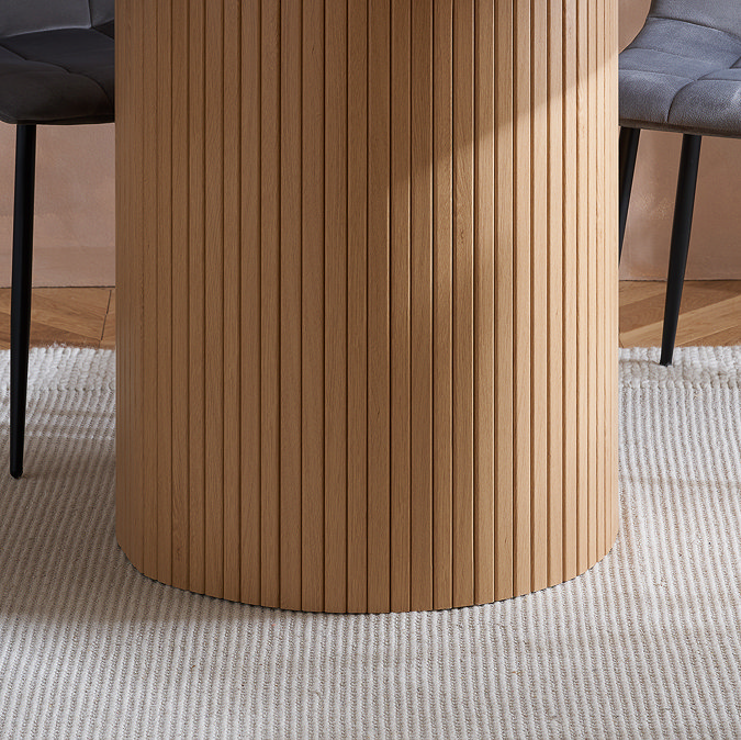 close up on fluted bottom of oak dining table