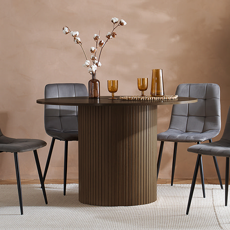 image of round walnut coloured dining table with fluted cylindrical base, four grey chairs around it
