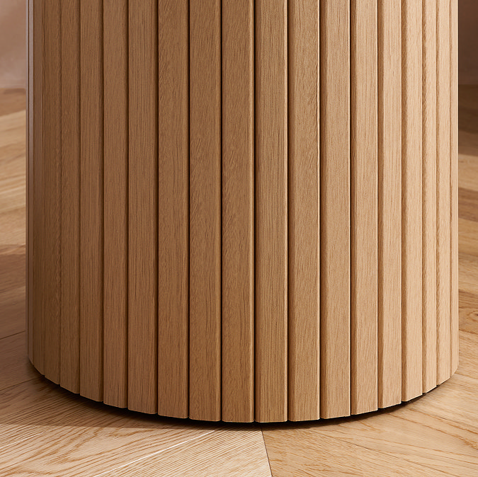 close up image of fluted cylindrical base of oak effect side table
