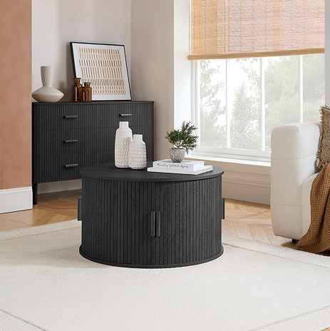 image of round fluted coffee table with doors pulled close, on cream rug
