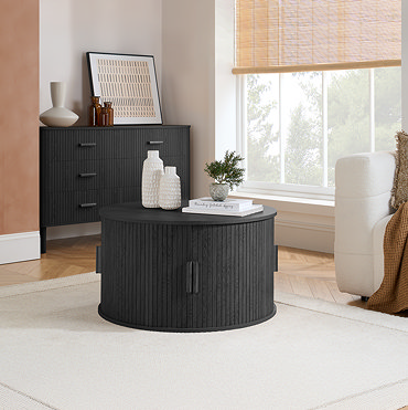 image of black round coffee table with drawers pulled open to show storage space within