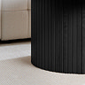 close up image of fluted lower half of black wooden coffee table