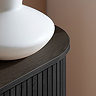 close up on smooth rounded edges of black fluted sideboard