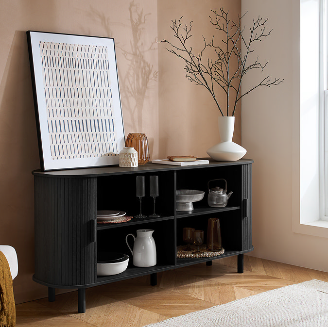 image of black fluted wooden sideboard with doors open to show storage space in use inside
