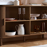 close up on open walnut sideboard with four shelves inside, stacked with crockery