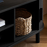 close up image of wicker basket in compartment space of black tv unit