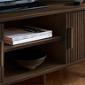 close up image of middle shelf section of tv unit behind fluted drawers