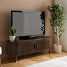 image of walnut wood effect fluted tv stand with tv on top, next to potted plant, with doors shut